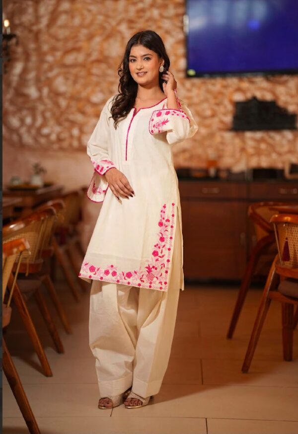 THIS ELEGANT OFF-WHITE STRAIGHT KURTA IS BEAUTIFULLY HIGHLIGHTED WITH VIBRANT PINK FLORAL EMBROIDERY ON THE NECKLINE, SLEEVES, AND HEM