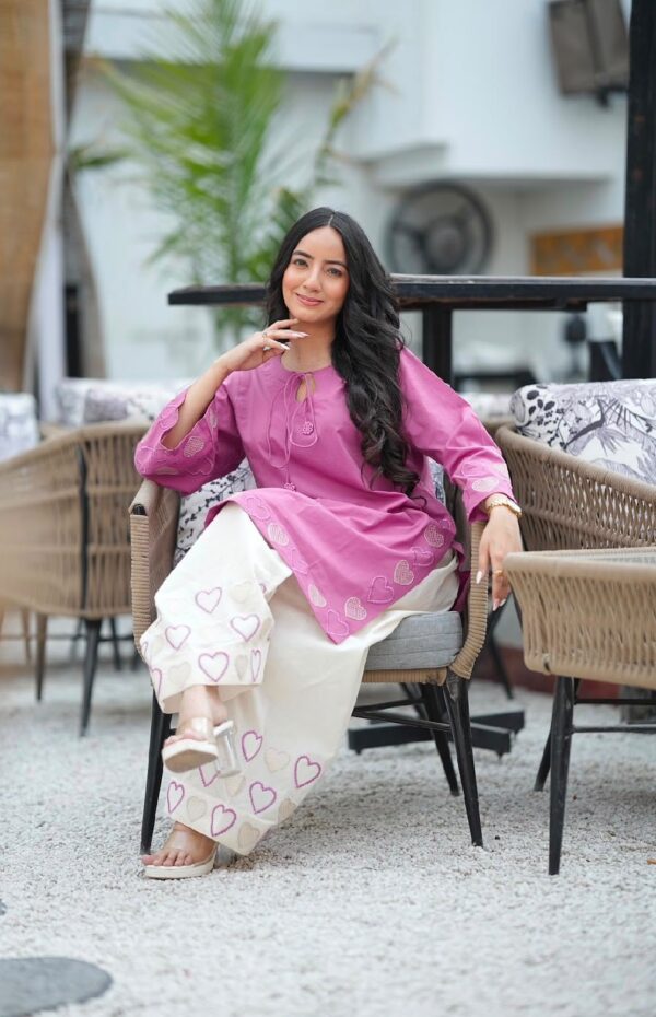 THIS VIBRANT PINK STRAIGHT KURTA IS DESIGNED WITH CHARMING HEART EMBROIDERY AND A DELICATE TIE-UP NECKLINE, ADDING A PLAYFUL YET ELEGANT TOUCH